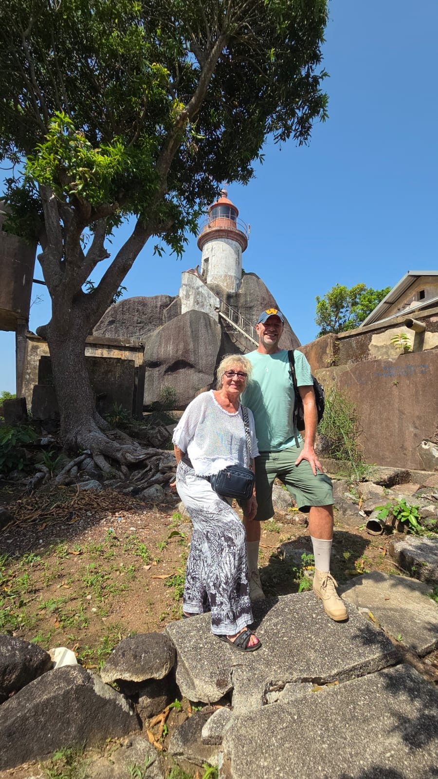 Travellers visiting an old lighthouse on the coast