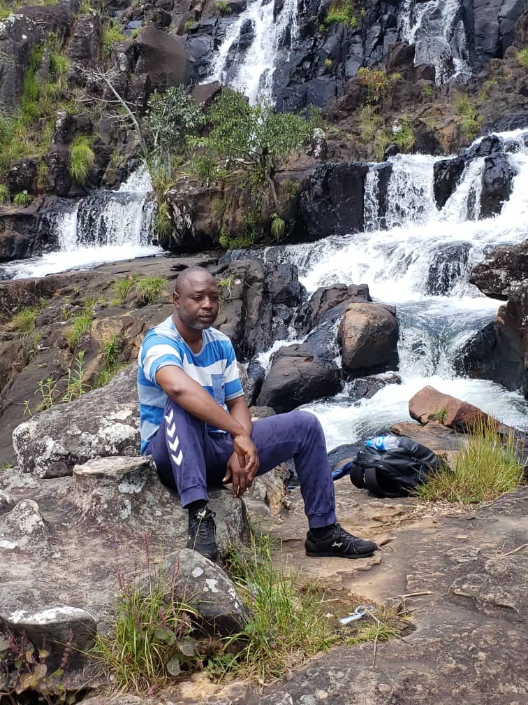 Sylla N'Faly, founder of Guinea Travel and Services, by a waterfall