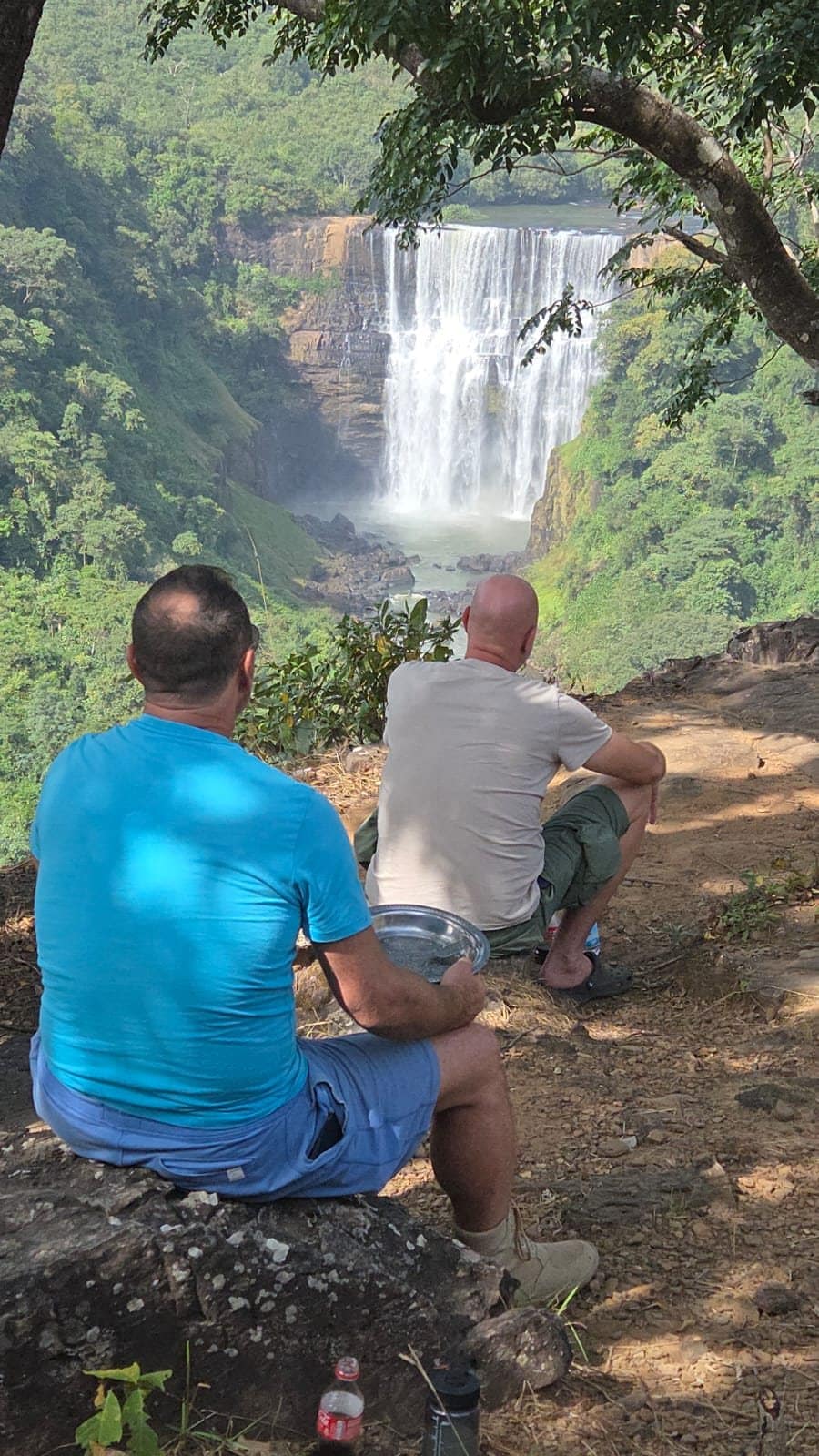 Travellers enjoying a waterfall viewpoint on a guided tour in Guinea