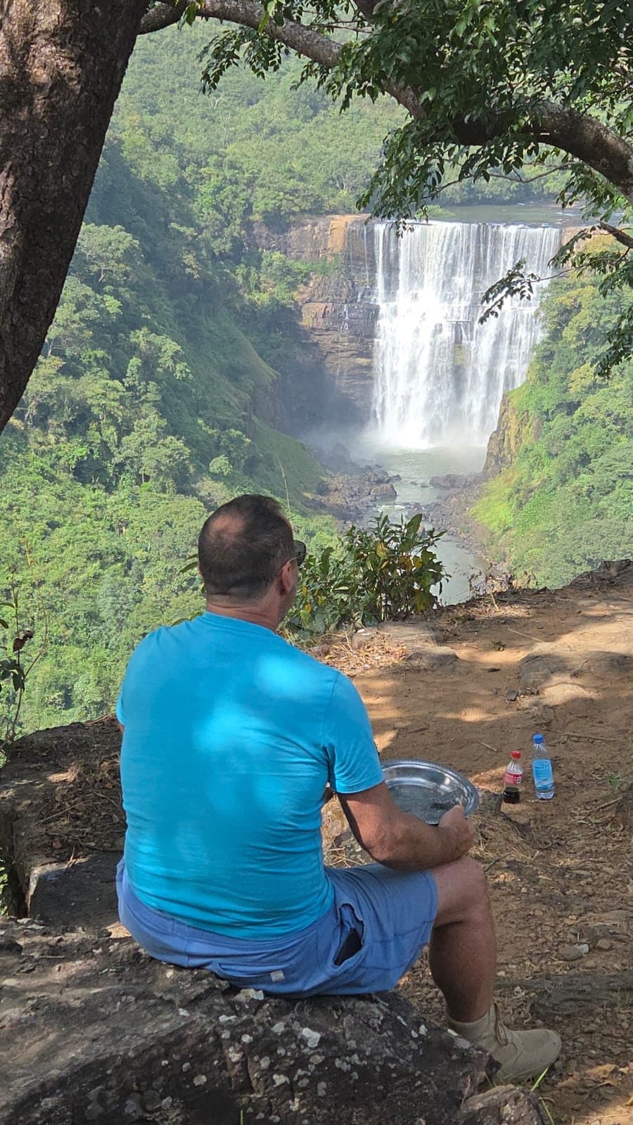 Traveller looking out over a large waterfall